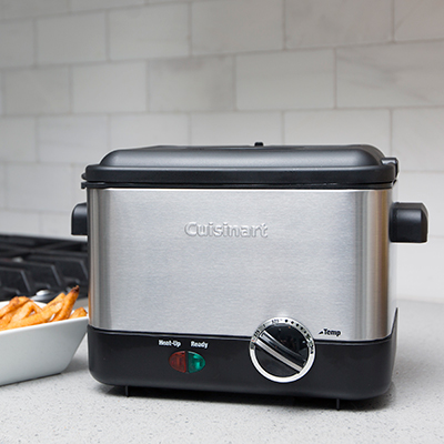 CUISINART<sup>&reg;</sup> Deep Fryer - This compact deep fryer offers restaurant-quality frying while saving on counterspace.  Stainless steel deep fryer heats to 375˚F and features smooth brushed stainless steel housing, stay-cool handles, sturdy die-cast aluminum frying bowl, fry basket and lid with viewing window and removable charcoal filter.  Uses up to 1 liter of oil and fries batches up to 3/4 lbs.