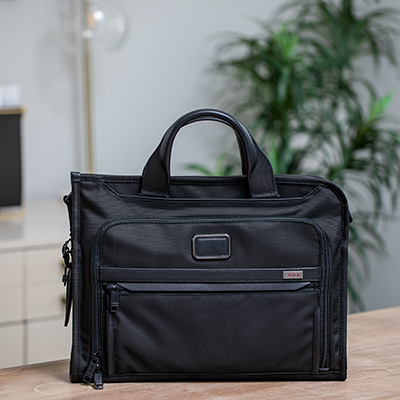 TUMI<sup>&reg;</sup> Alpha 3 Slim Deluxe Portfolio - This slim portfolio-style brief is well organized for your business or travel needs.  It features a zip-around opening for easy access to the main compartment. The interior features a padded tablet pocket, multiple pockets for accessories, and a magnetic slip pocket on the front.  Bag measures  12&quot;H x 16&quot;W x 3&quot;D.  Also features removable, padded shoulder strap and leather top carry handles.